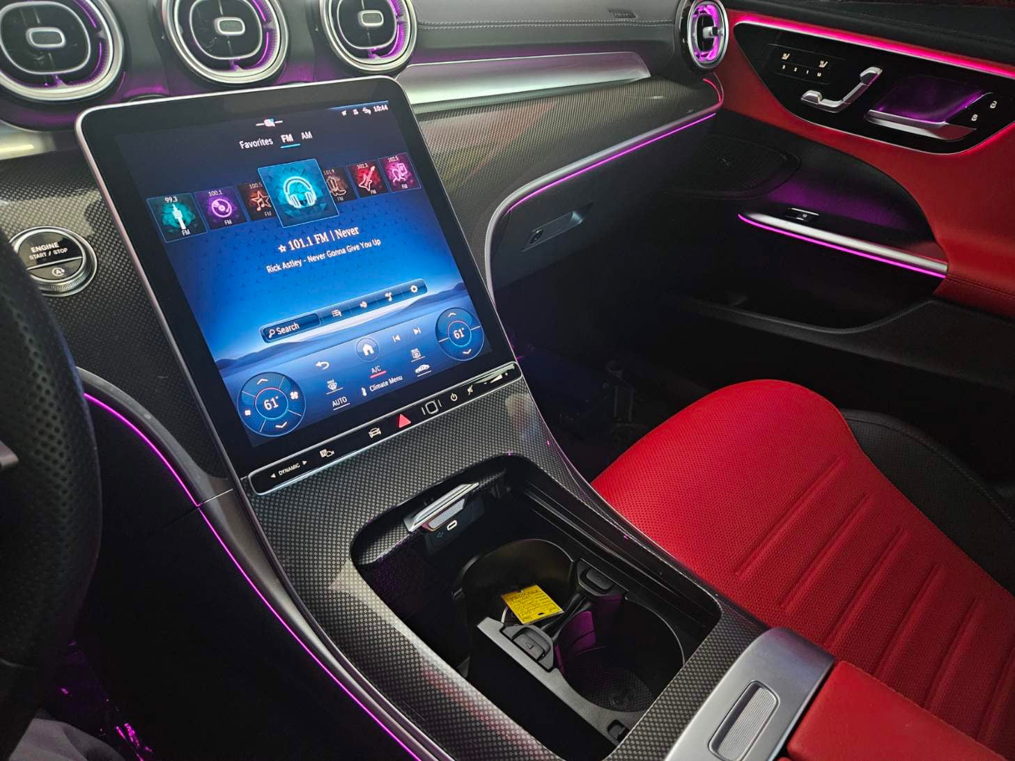Car interior with a digital display and red seat