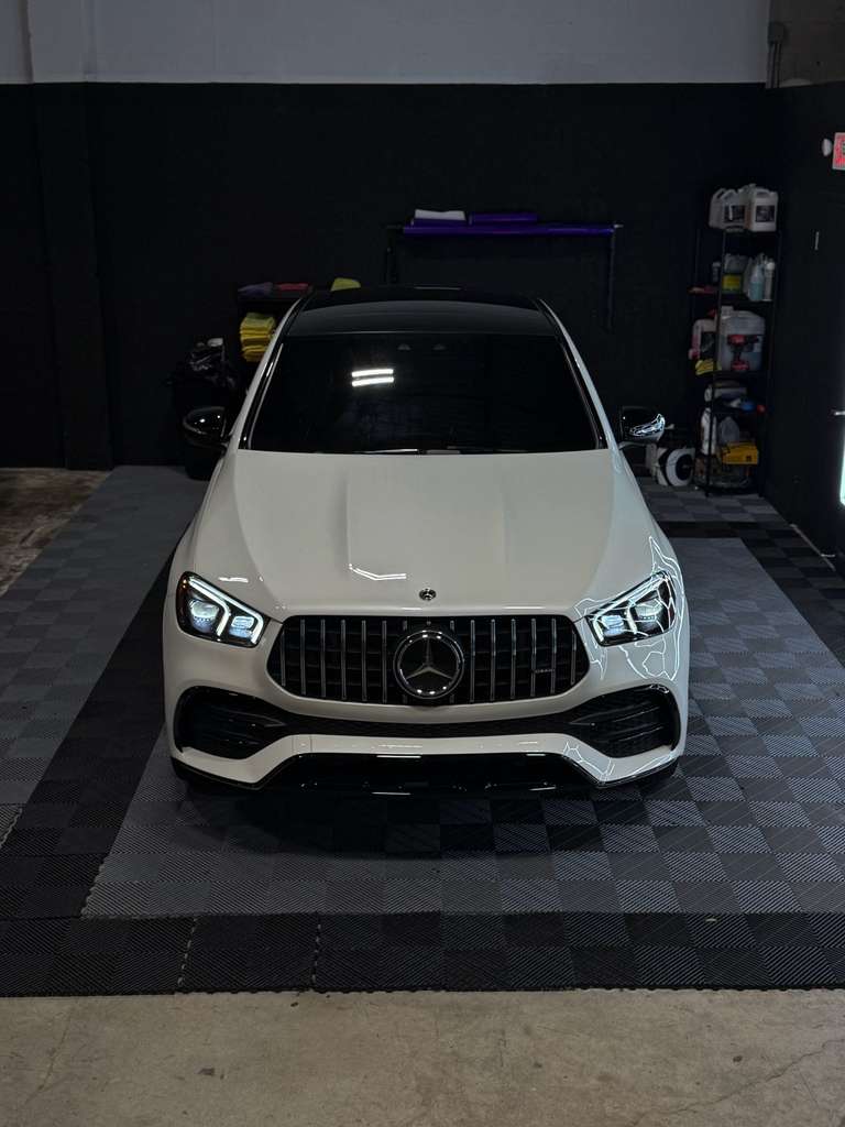 White Mercedes-Benz car in a showroom setting