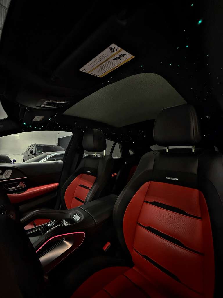 Car interior with red and black seats in a showroom setting