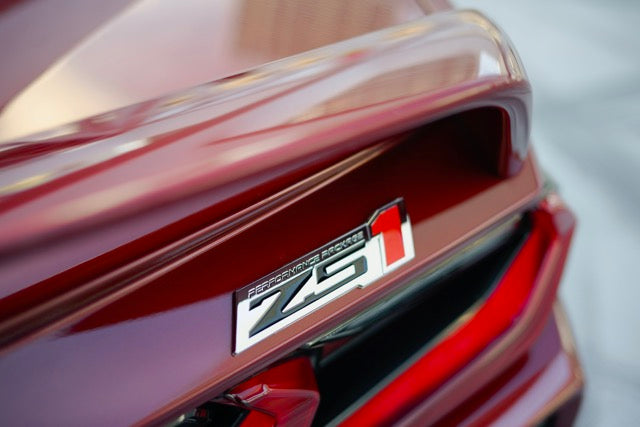 Close-up of a red car with a 'Z51' badge on a blurred background