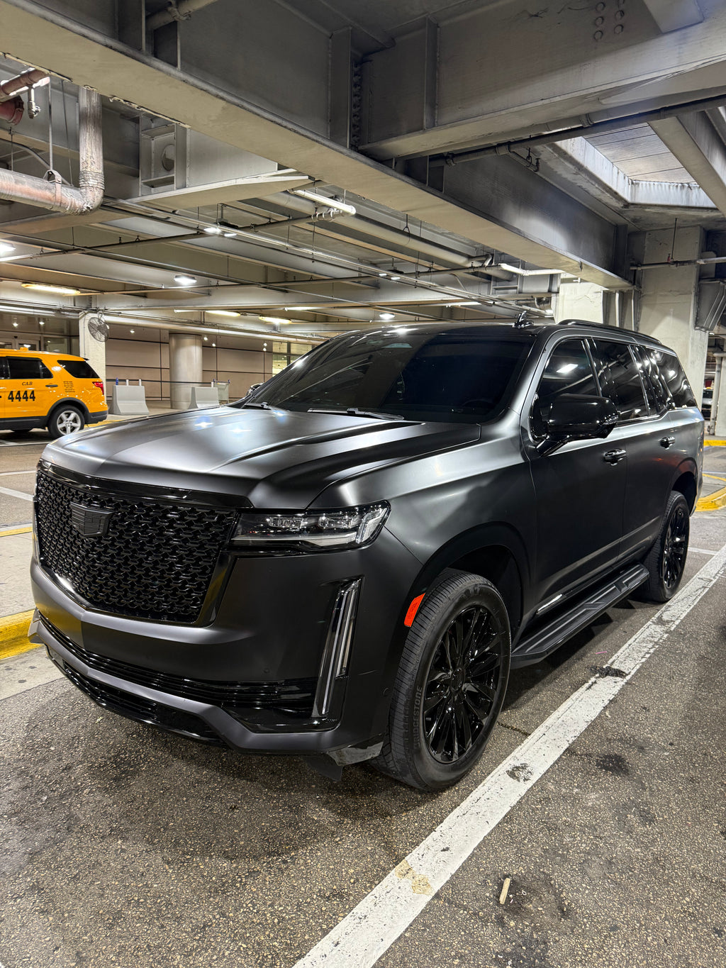 Black SUV parked in a parking garage