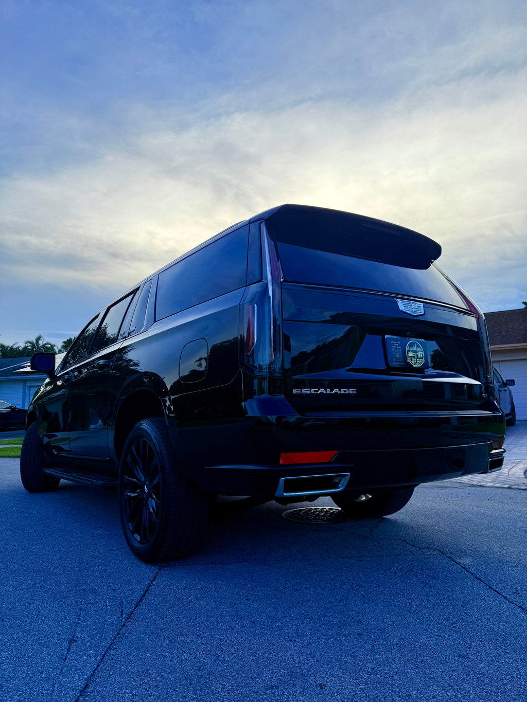 Black van parked on a concrete surface with a blue sky in the background