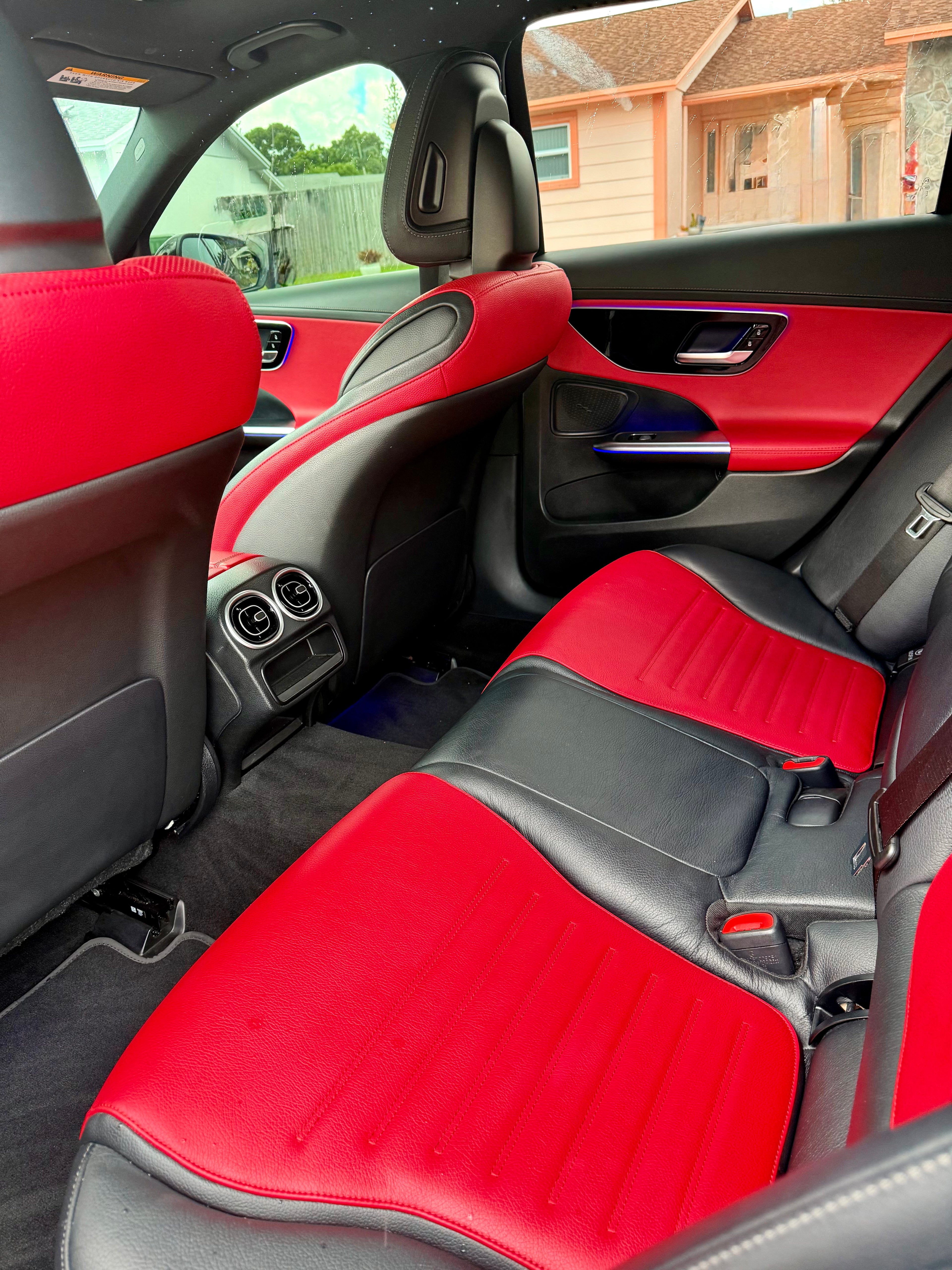 Car interior with red and black seats and door panels.