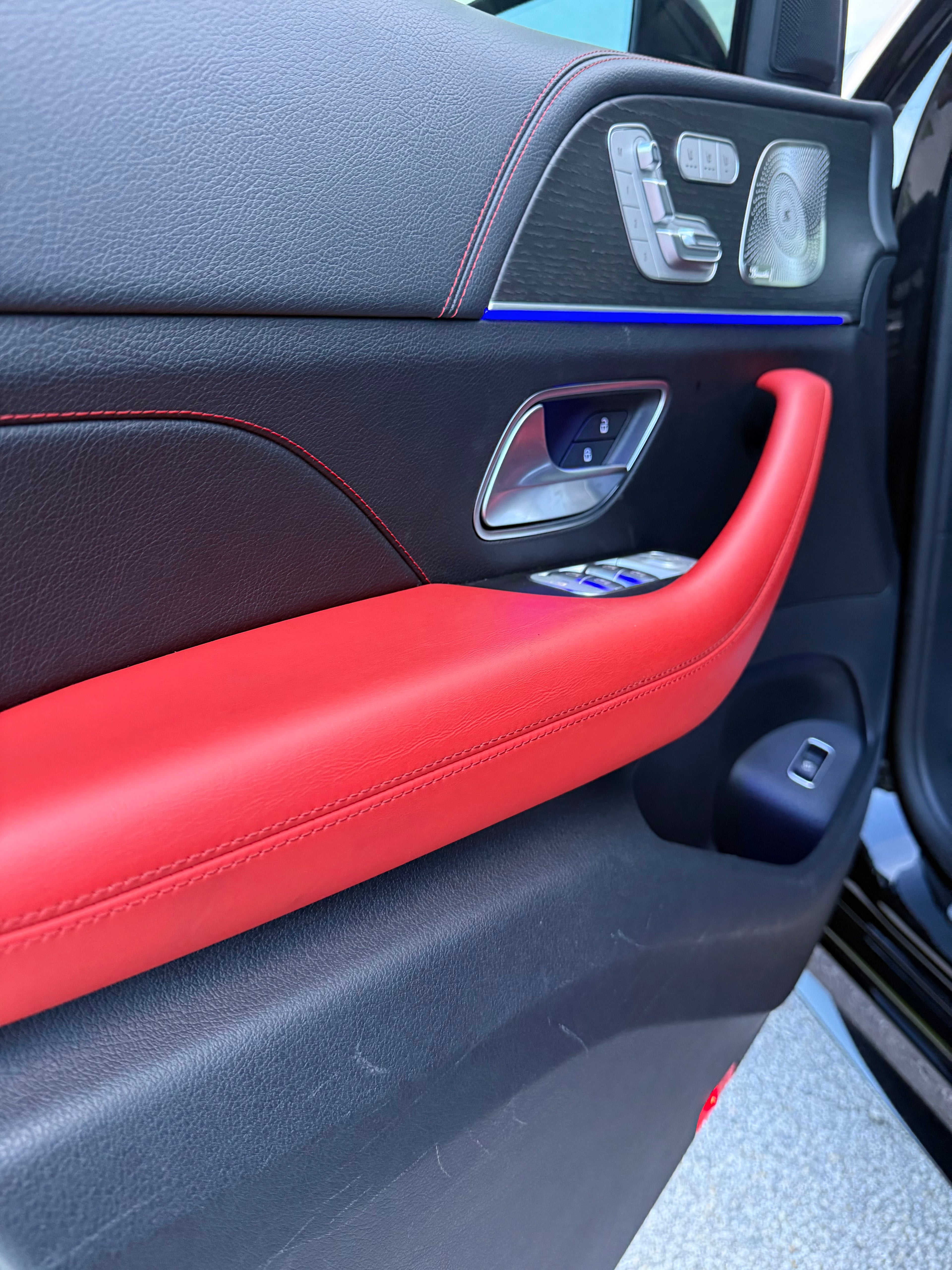 Car door interior with red handle and black panel