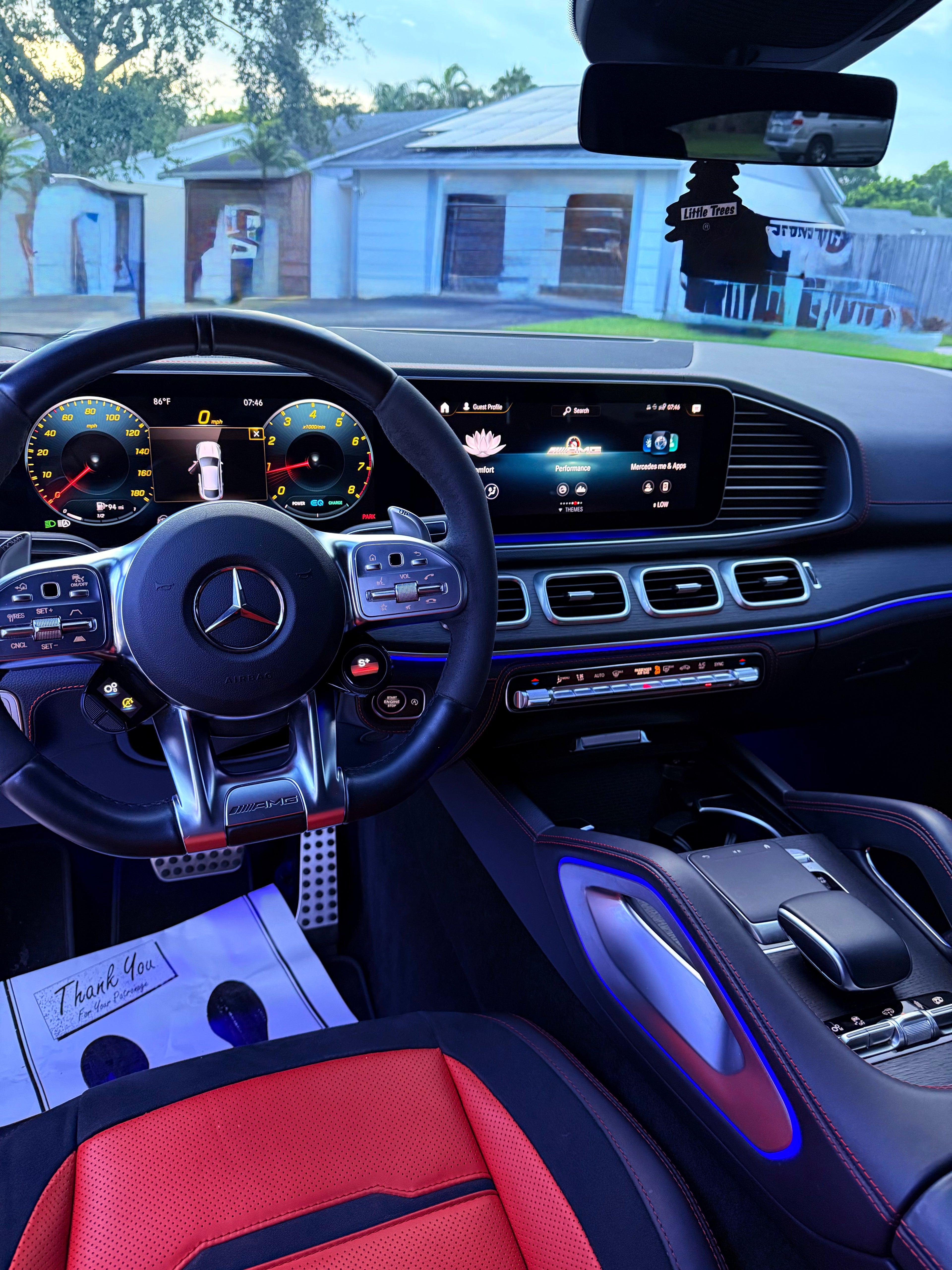 Mercedes GLE53 Car interior with steering wheel and dashboard.