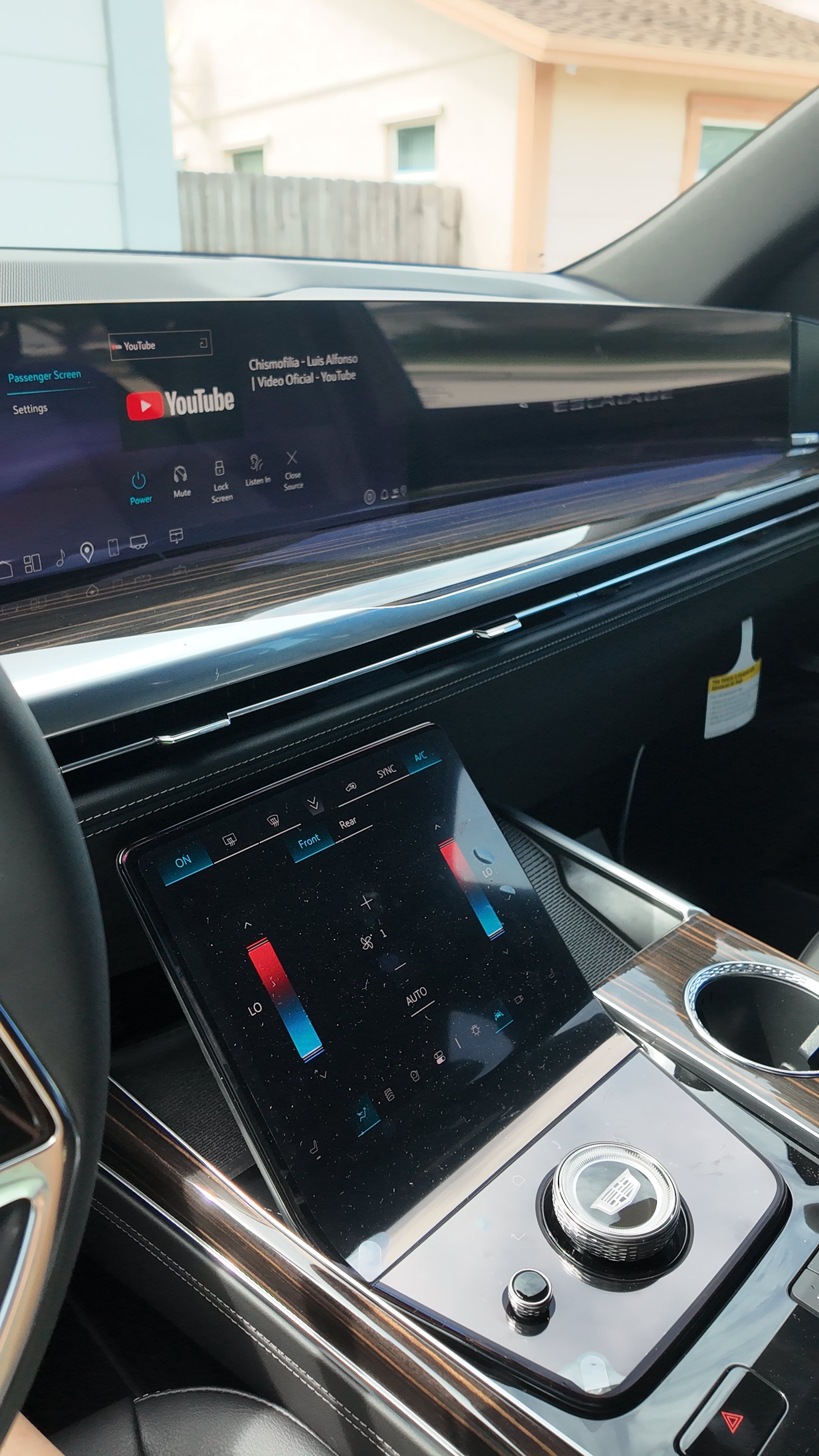 Car interior with digital display showing YouTube interface